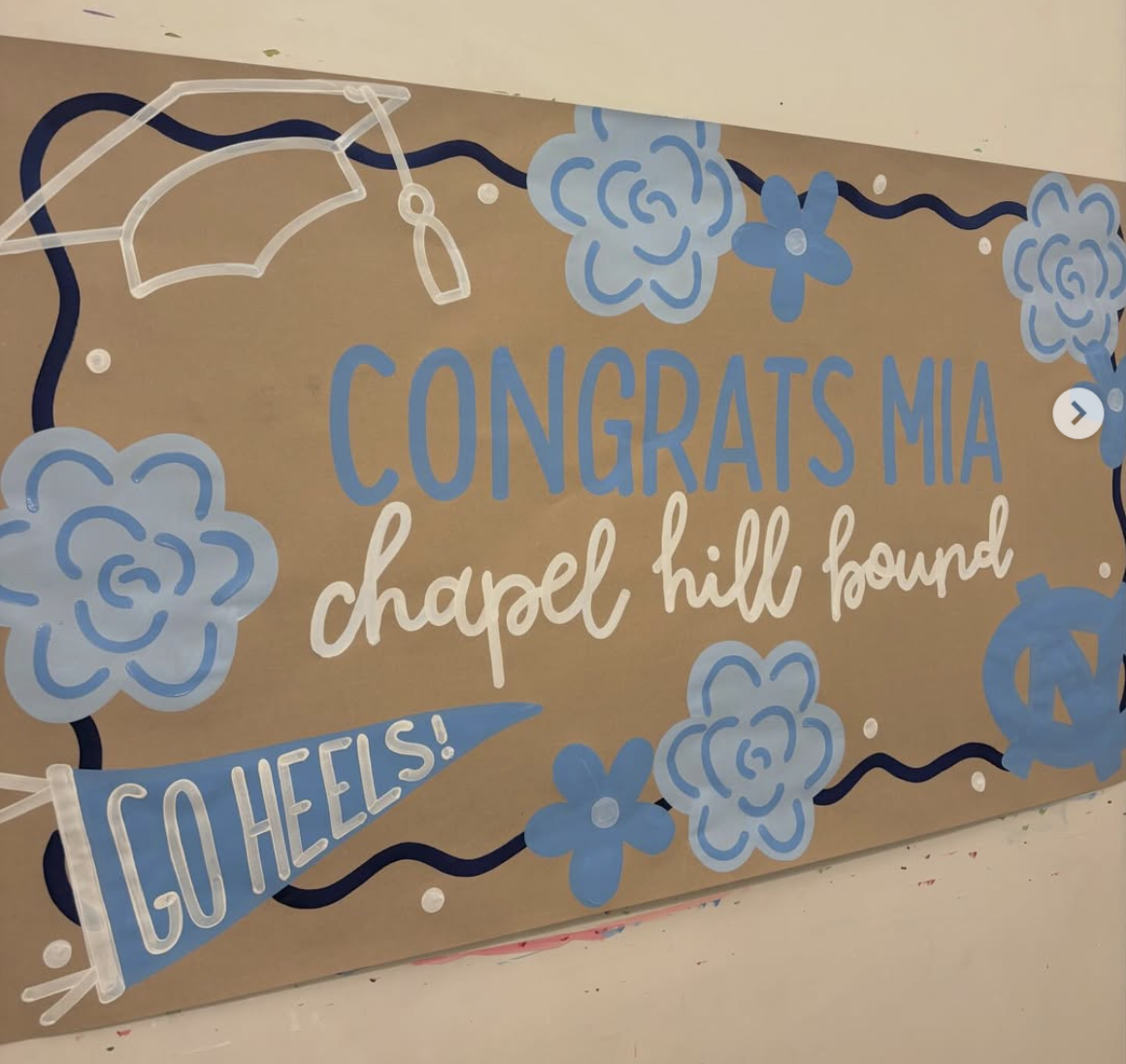 Carolina blue graduation banner reading Congrats Mia, Chapel Hill Bound, Go Heels