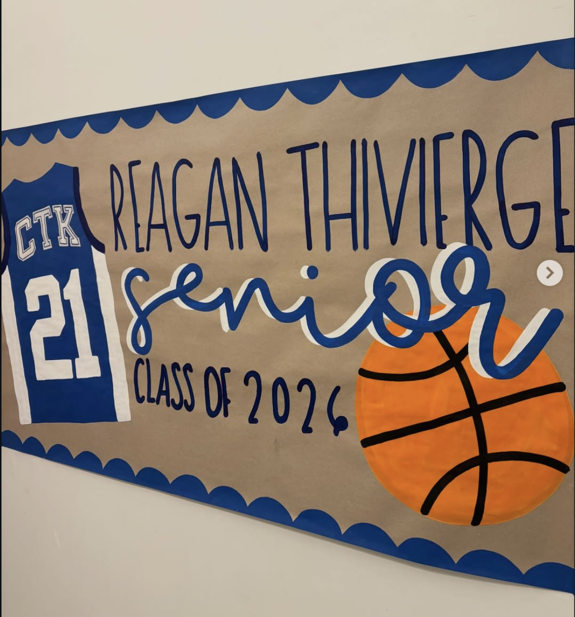Blue and orange senior basketball banner with jersey number 21 reading Reagan Thivierge Senior Class of 2026
